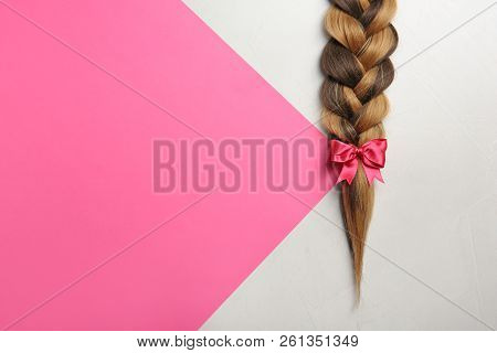 Braid And Space For Text On Color Background, Top View. Healthy Hair