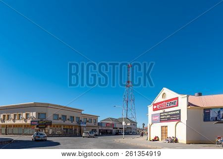De Aar, South Africa, August 6, 2018: A Street Scene, With Businesses, Vehicles And People, In De Aa