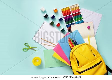 School Stationary Sets And Knapsack On Blue Background.