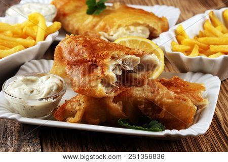 Traditional British Fish And Chips Consisting Of Fried Fish, Potato Chips And Mayonnaise