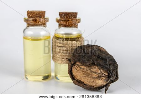 Oil In A Bottle And Walnuts On A White Kitchen Table. Spices And Ingredients Useful In Kuchi.