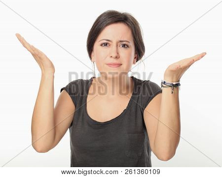 Young Brunette Woman Spread Hands And Do Not Know The Answer