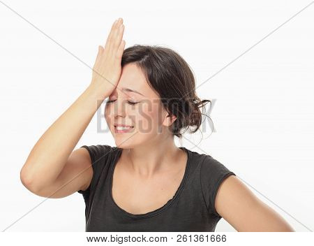 Young Pretty Woman Keeping Her Hand To Head And Remembered Something