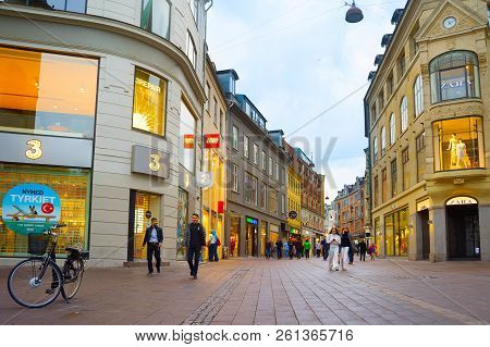 Copenhagen, Denmark - June 16, 2018: People Walk By The Stroget Street - The Main Shopping Street Of