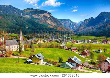 Alpine Green Fields And Traditional Wooden Houses View Of The Gosau Village At Autumn Sunny Day. Loc