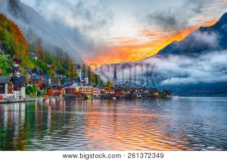 Scenic View Of Famous Hallstatt Mountain Village With Hallstatter Lake. Foggy Autumn Sunrise On Hall