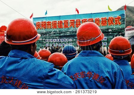Labrang Monastery, Xiahe, Gansu Province / China - Jun 6 2011: Workers Are Waiting Lined Up For An O