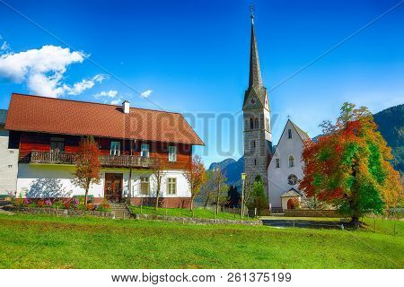 Mountains Over Gosau Village With Catholic Church Under Sunlight. Location: Resort Village Gosau Sal