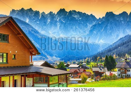 Alpine Green Fields And Traditional Wooden Houses View Of The Gosau Village At Autumn Sunny Day. Loc