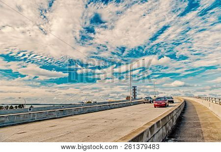 Miami Highway Or Public Road Roadway For Transport Vehicles And Urban Skyscrapers On Cloudy Blue Sky