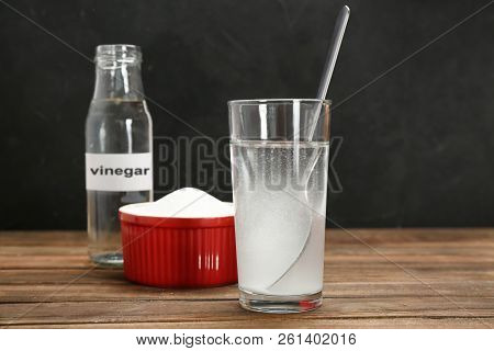 Glass With Water And Baking Soda On Wooden Table