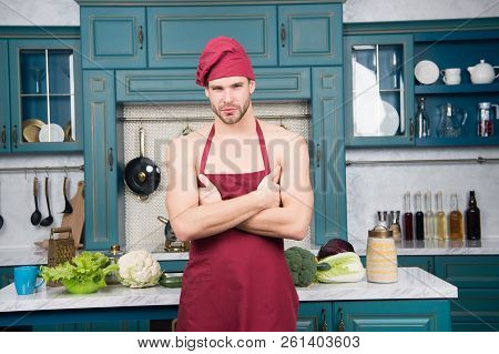 Man Attractive Nude Chef Wear Apron And Hat. Sexy Muscular Chef In Front Of Kitchen. Attractive Chef