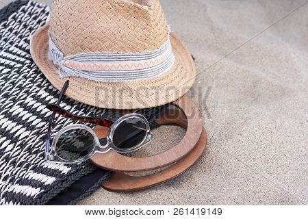 Vintage Summer Wicker Straw Hat With Colorful Ribbon, Beach Wicker Bag And Sunglasses On The Beach