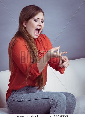 Angry, Pissed Off Young Woman. Attractive Female With Long Brown Hair Sitting On Sofa Being Mad And 