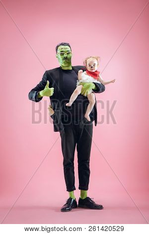 Halloween Family. Happy Father And Children Newborn Girl In Halloween Costume And Makeup. Bloody The