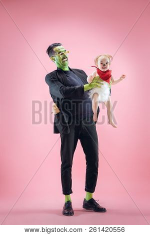 Halloween Family. Happy Father And Children Newborn Girl In Halloween Costume And Makeup. Bloody The