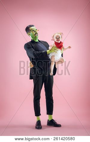 Halloween Family. Happy Father And Children Newborn Girl In Halloween Costume And Makeup. Bloody The