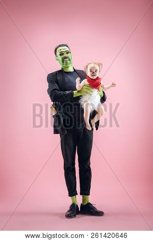 Halloween Family. Happy Father And Children Newborn Girl In Halloween Costume And Makeup. Bloody The