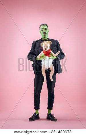 Halloween Family. Happy Father And Children Newborn Girl In Halloween Costume And Makeup. Bloody The