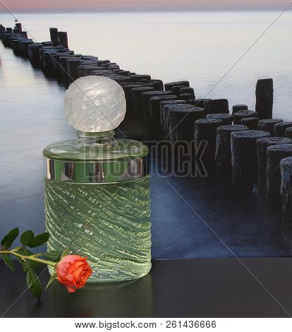 Fragrance For Ladies, Large Perfume Bottle In Front Of The Picture Of A Groyne In The Sea Decorated 