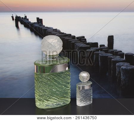 Fragrance For Ladies, Large Perfume Bottle Next To A Commercial Perfume Bottle In Front Of The Pictu