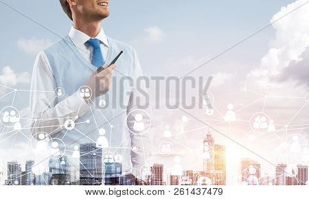 Double Exposure Of Confident And Young Businessman In Smart-casual Wear Smoking Pipe And Modern City