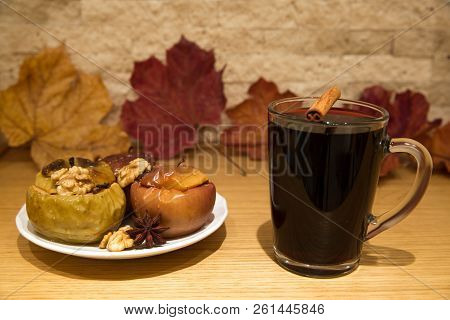 Hot Mulled Wine And Baked Apples With Spices, Walnuts, Cinnamon Sticka, Cloves And Anise Stars, Autu