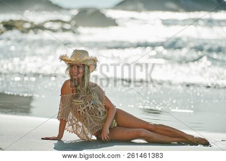 young woman relaxing on the beach in summer day