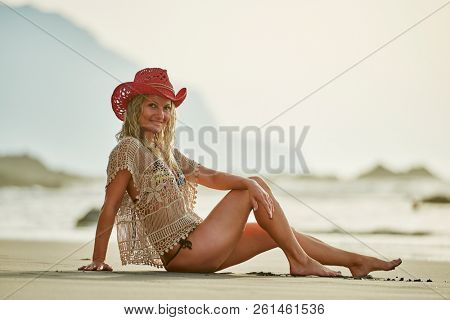 young woman relaxing on the beach in summer day
