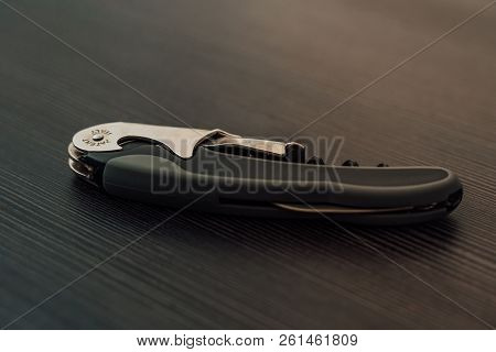 Multiple Bottle Opener Lying On A Black Table
