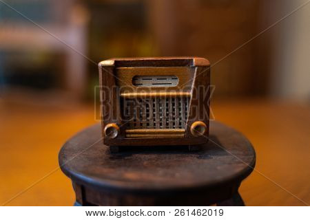 Old Doll Radio Stands On A Small Doll Table