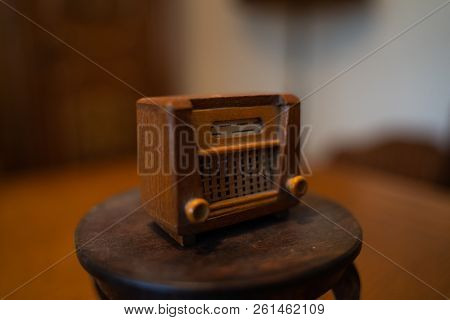 Old Doll Radio Stands On A Small Doll Table