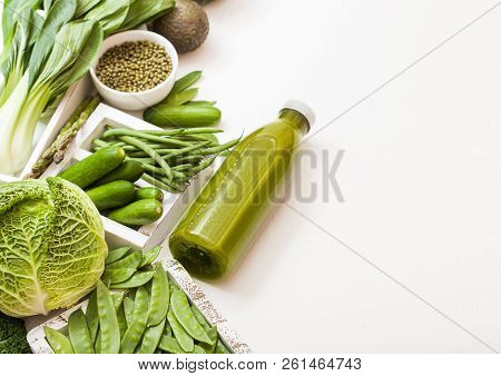 Assorted Green Toned Raw Organic Vegetables On White Stone Background. Avocado, Cabbage, Cauliflower