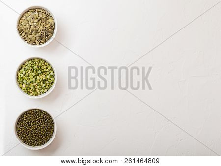 Bowl Of Mung Beans And Split Peas And Pumkin Seeds On White Kitchen Background