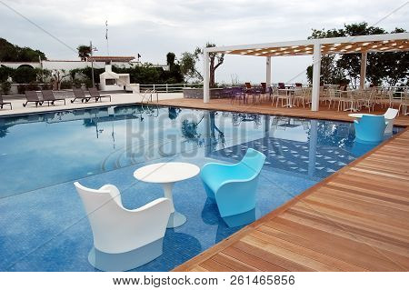 Litochoro, Greece - May 08, 2012: Stylish White And Blue Armchairs And A Round White Table In The Bl