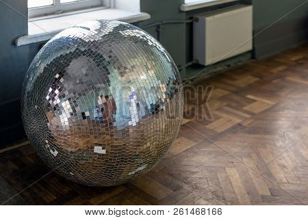 Removed Old Disco Ball On Hardwood Wooden Floor. Needless Nightclub Accessory From Past. End Of Part