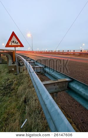 La veleta en una señal de advertencia el tráfico por fuertes vientos en el puente de la autopista