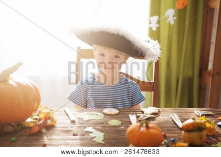Cute Little Boy Wearing Pirate Costume On Halloween Trick Or Treat. Kids Carving Pumpkin Lantern. Ch