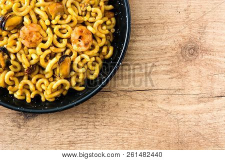 Traditional Spanish Fideua. Noodle Paella On Wooden Table. Top View. Copyspace
