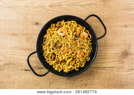 Traditional Spanish Fideua. Noodle Paella On Wooden Table. Top View.