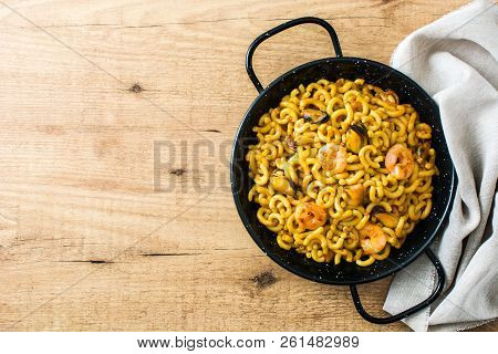 Traditional Spanish Fideua. Noodle Paella On Wooden Table. Top View. Copyspace
