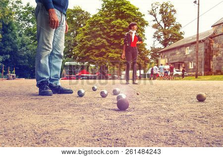 Man And Woman Playing Petanque In Th Park On Holidays