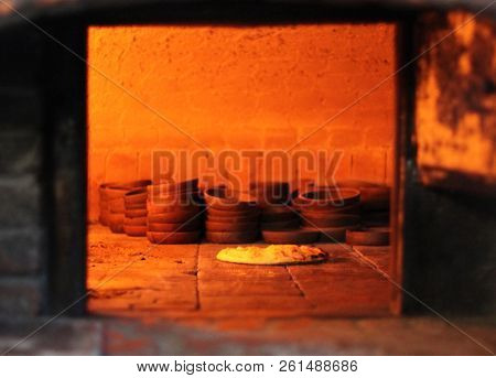 Georgian flat cake with cheese (khachapuri) in the oven