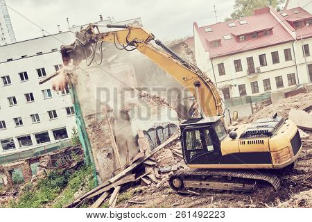 excavator crasher machine at demolition on construction site