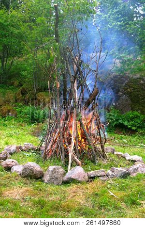 Starting A Fire At The Fireplace In Peaceful Forest.
