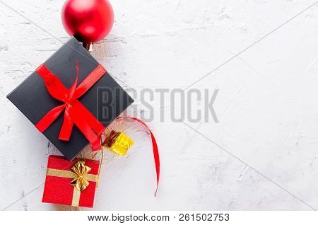 Christmas Decorative Background With Fir Branches, Cones, Redr And Black Christmas  Gifts, Ball On T