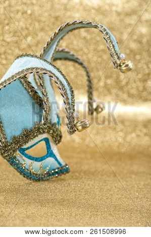 Carnival Mask Harlequin On Golden Background. Symbol Of Venetian Mask Festival. Selective Focus
