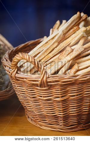 Grissini Breadsticks, Sesame-covered Bread Sticks. Fresh Bread Sticks In A Basket