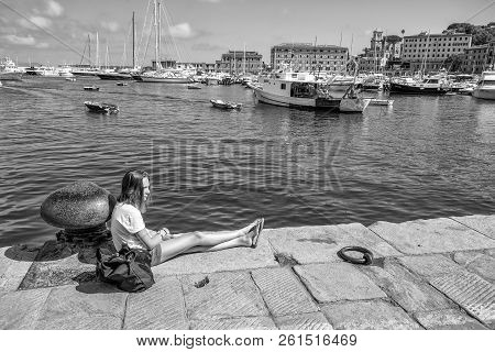 Santa Margherita Ligure, Italy, July, 12, 2017 - Young Girl Relaxes In The Port Of Santa Margherita 