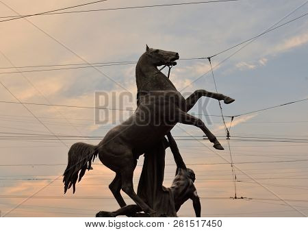 Statue Of The Conquest Of A Horse On The Anichkov Bridge At Sunset, Saint Petersburg, Russia.